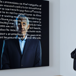 A contemplative professional man, fully clothed in a modest, dark business suit, stands in a serene, minimalist virtual memorial space. Soft, ethereal holographic projections of family-friendly, cherished memories float gently around him, including a warm, blurry image of a childhood scene, a peaceful landscape, and gracefully flowing digital text resembling a heartfelt message. The environment is imbued with a comforting, respectful atmosphere, enhanced by subtle, warm digital lighting that suggests a blending of technology and emotion. Professional photography, high resolution, soft focus, safe for work, appropriate content, fully clothed, professional dress, perfect anatomy, correct proportions, natural pose, well-formed hands, proper finger count, natural body proportions, modest.